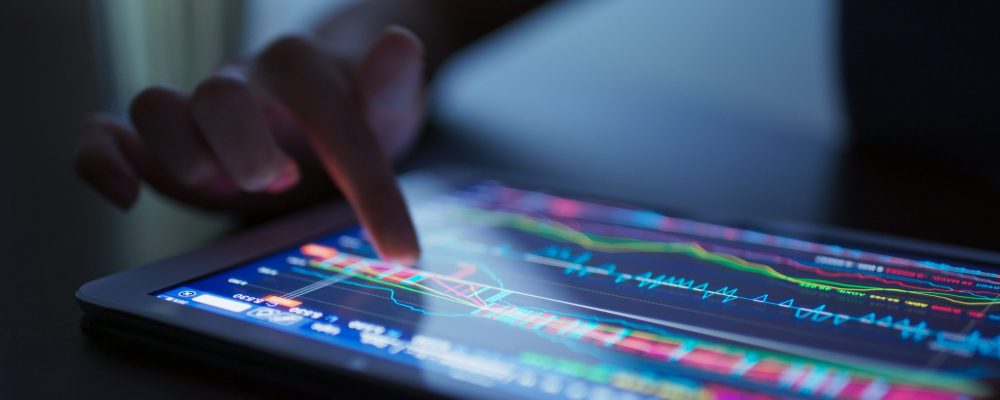 Finger touch on tablet computer with stock market data